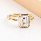 Angled top view of 3 Carat Emerald Cut Lab Grown Diamond Ring in yellow gold with vintage milgrain bezel frame
