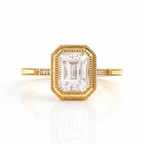 Direct top-down studio view of 3 Carat Emerald Cut Lab Diamond Ring in yellow gold with reflection