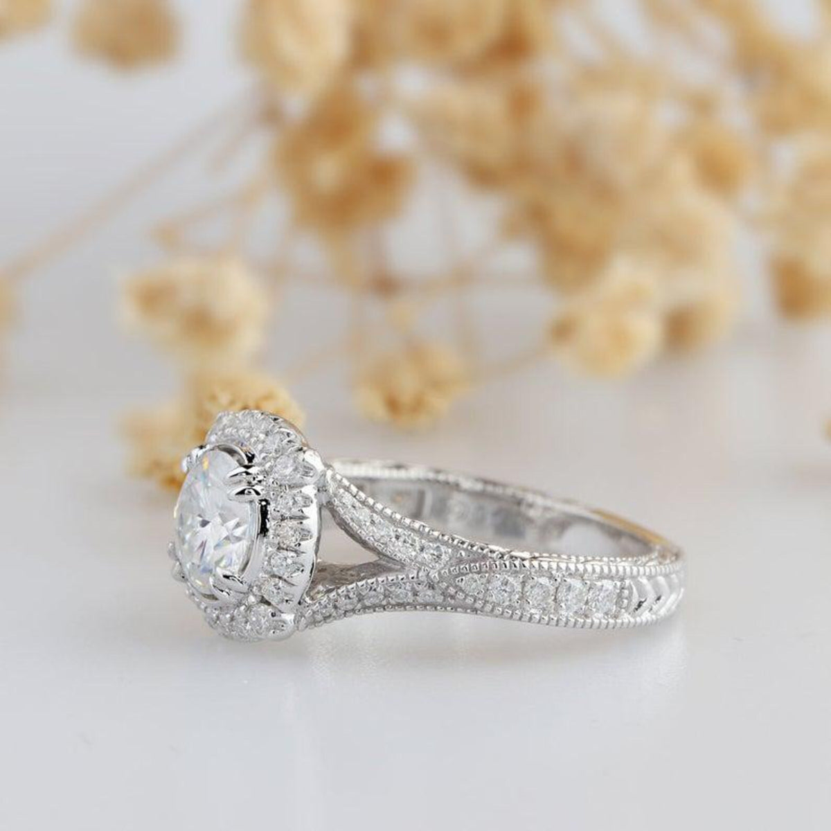 Side angled view of 3 Carat Round Cut Lab Grown Diamond vintage halo engagement ring with split shank and milgrain edges