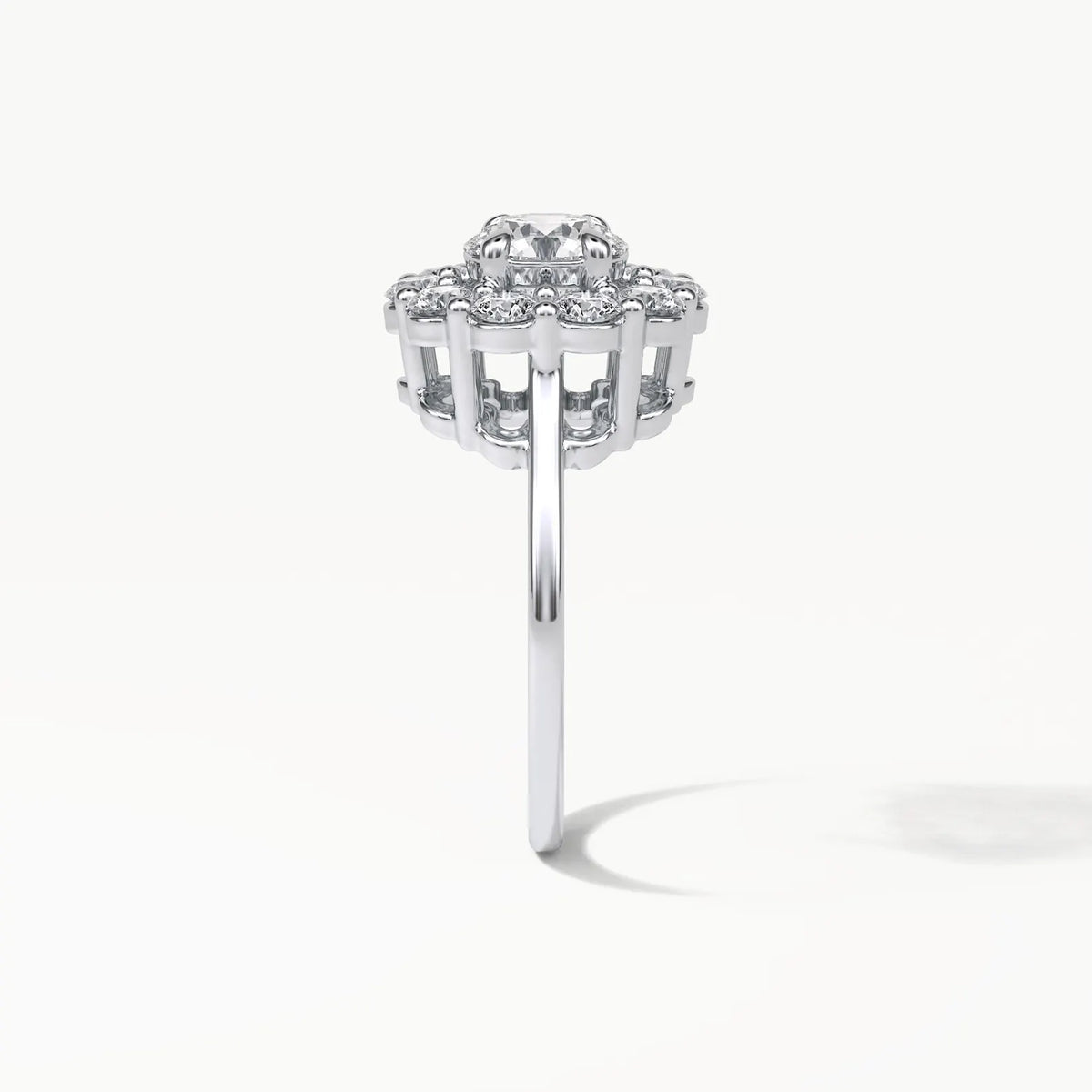 Side profile view of a 3 carat round cut lab grown diamond engagement ring with an elevated floral basket setting in white gold.
