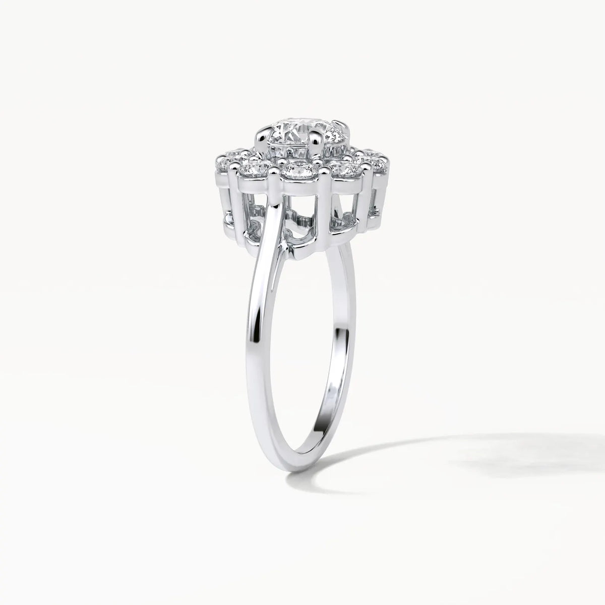 Three-quarter vertical perspective of a 3 CT lab diamond engagement ring with a high floral gallery and smooth metal band.