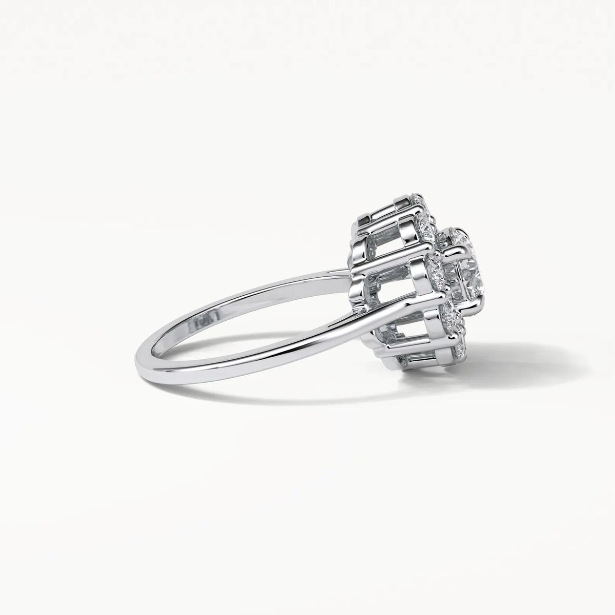 Low angle perspective detailing the intricate multi-tier prong setting and open gallery design of the lab diamond ring.
