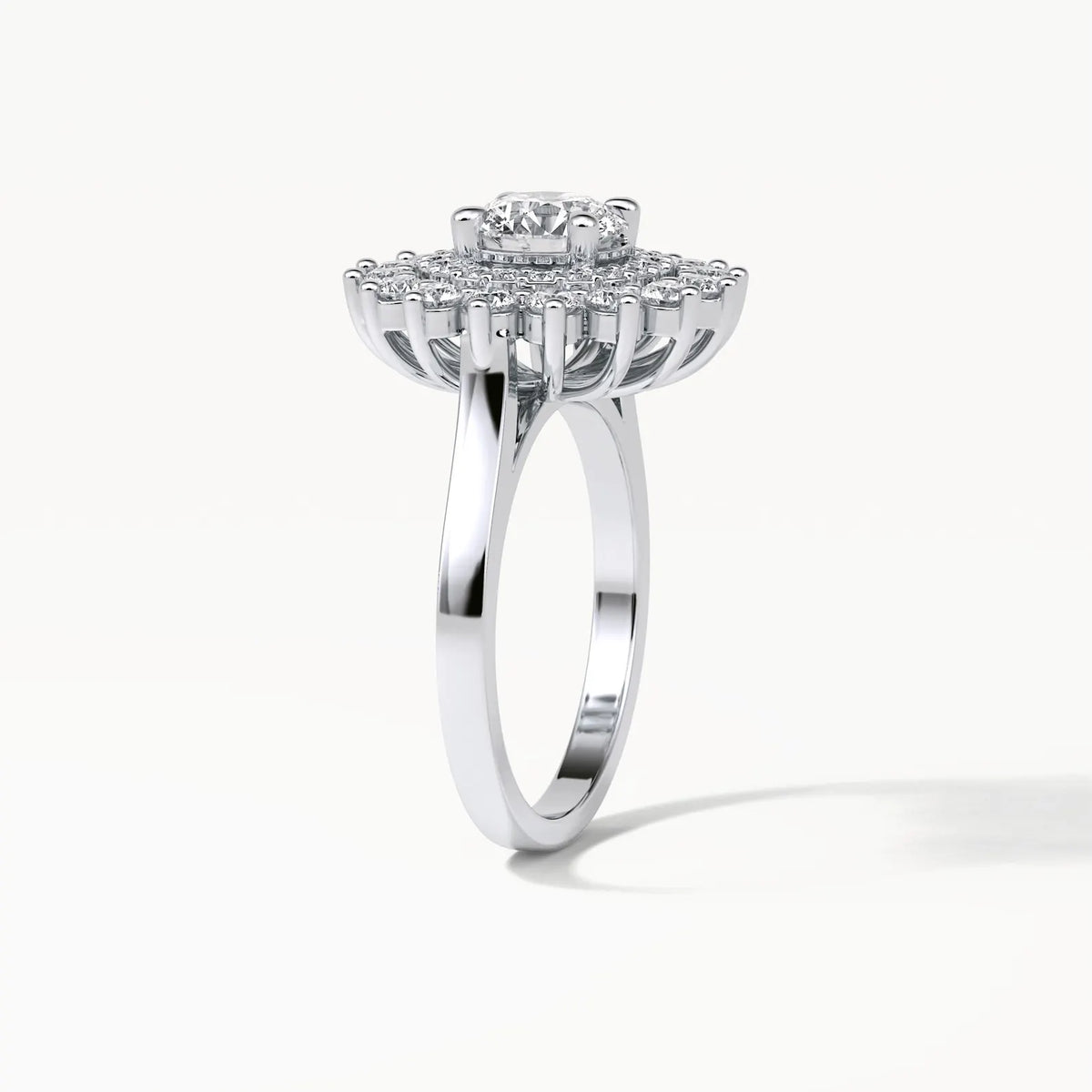 Three-quarter side angle showing the elevated double halo setting and smooth white gold band of a 3ct lab diamond ring.