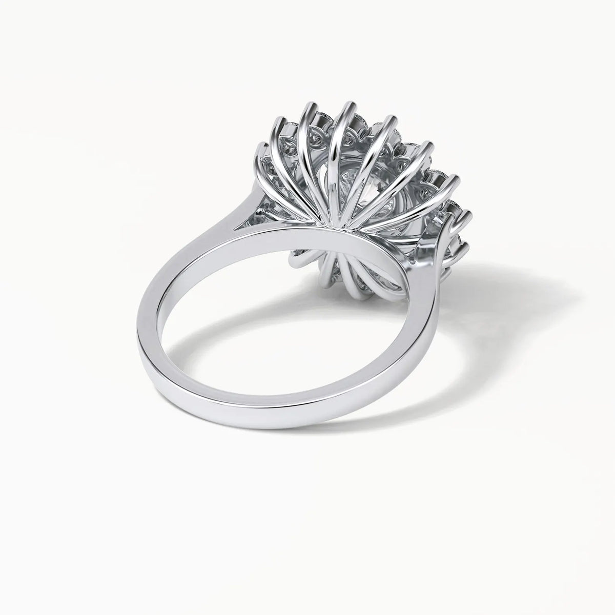 Underside detail view of a lab grown diamond engagement ring showing the radiating fan-like wire basket setting.