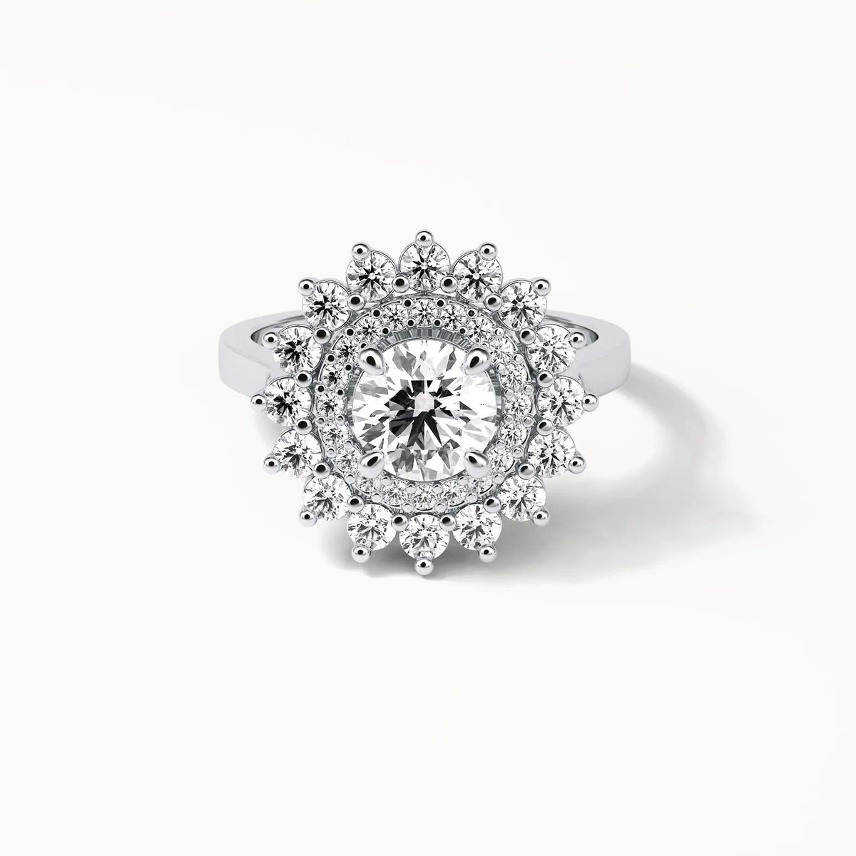 Direct top-down view of a 3 CT round cut lab grown diamond in a multi-tier sunburst double halo mounting.