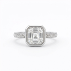 Top-down view of a 3 CT Asscher cut lab diamond set in a white gold bezel ring with milgrain edging and engraved leaf band.