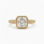 Front top-down view of a 3 CT Asscher cut lab diamond engagement ring in yellow gold with milgrain bezel and botanical engraved band.