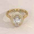 High angle view of a 3 CT oval lab grown diamond engagement ring with a dramatic triple micro-pave halo set in polished 14K yellow gold.