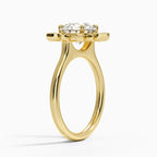Profile angle showing the cathedral arch support beneath a sunflower petal lab diamond halo setting in yellow gold.
