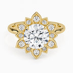 Top-down view of a 3 carat round cut lab grown diamond surrounded by a pave-set sunflower petal halo in yellow gold.