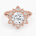 Direct top view of a 3 CT round brilliant lab grown diamond engagement ring with a starburst petal halo set in rose gold.