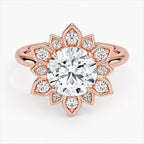 Direct top view of a 3 CT round brilliant lab grown diamond engagement ring with a starburst petal halo set in rose gold.