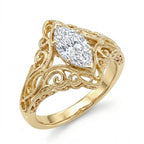 Perspective view of a 3 CT marquise lab grown diamond engagement ring featuring detailed scroll filigree and milgrain borders in 14K yellow gold.
