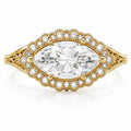 Direct overhead view of a 3 CT East-West marquise cut lab grown diamond set horizontally in a scalloped beaded pave diamond halo.