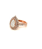 Side angle view of a 2 CT pear cut lab grown diamond engagement ring with a double halo setting and diamond band in rose gold