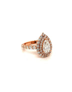 Perspective view of a 2 CT pear cut double halo lab diamond engagement ring showing the rose gold setting and diamond-accented shank.