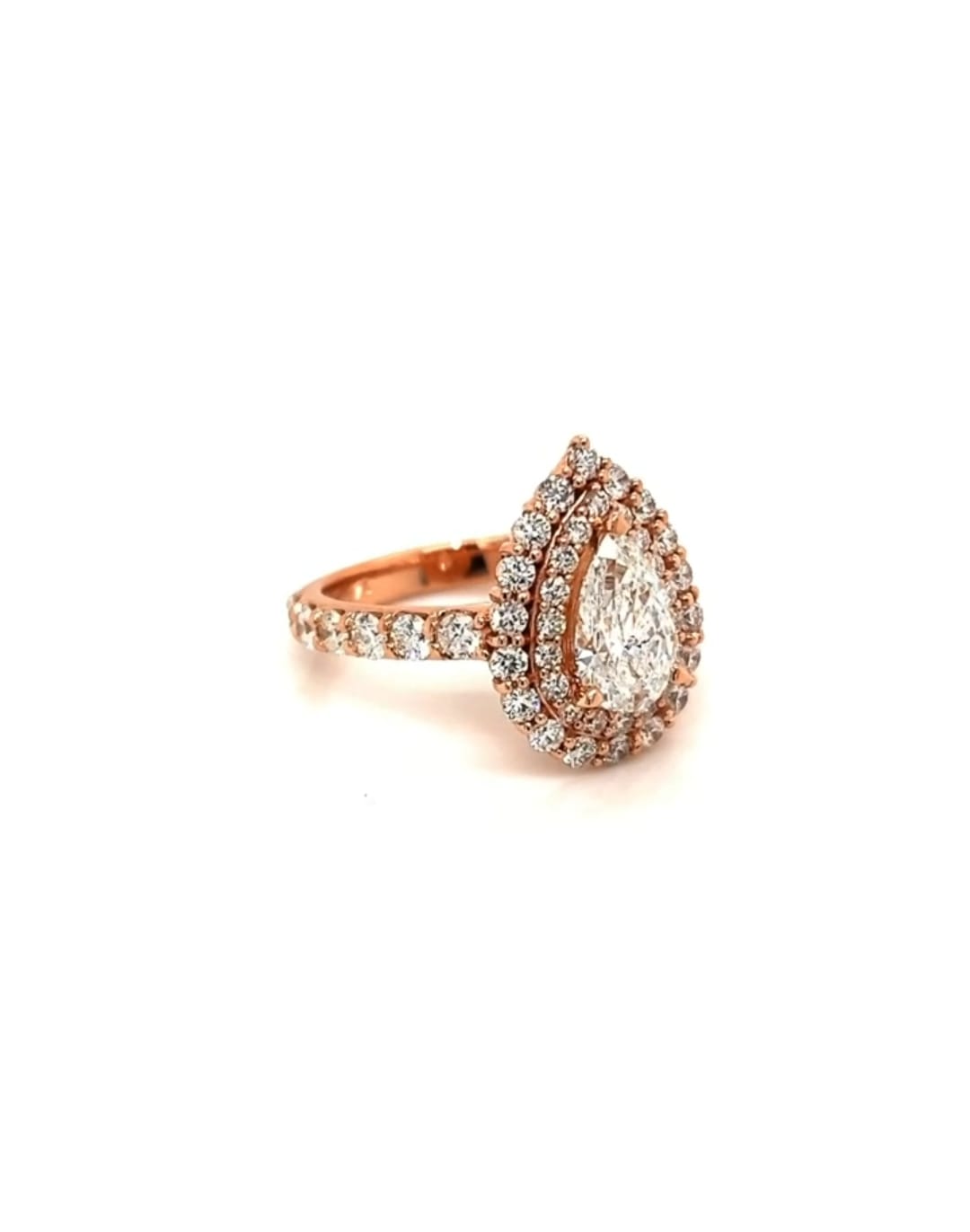 Perspective view of a 2 CT pear cut double halo lab diamond engagement ring showing the rose gold setting and diamond-accented shank.