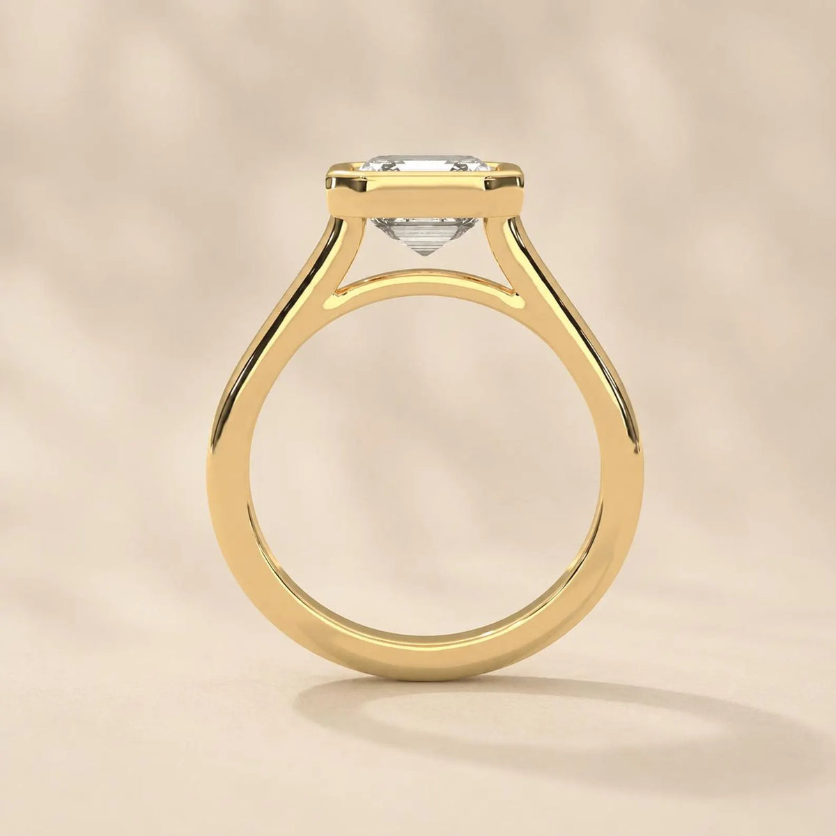Side profile view of yellow gold bezel set Asscher cut engagement ring