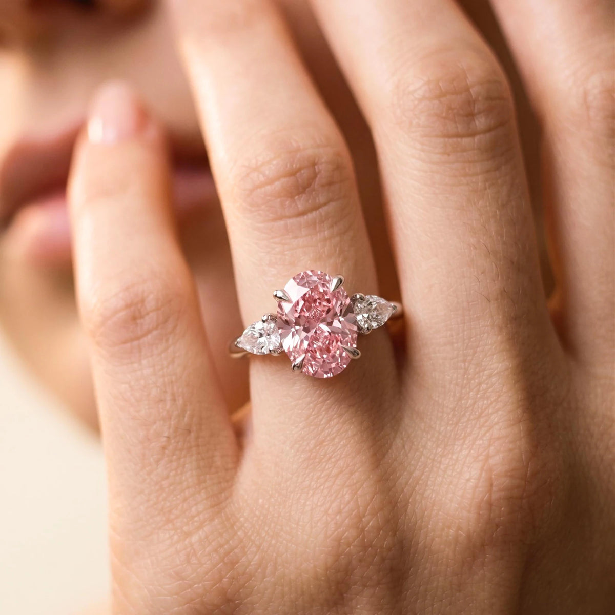 3 Carat oval cut pink lab grown diamond three stone ring worn on hand