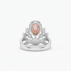 Back view of a pink pear cut lab grown diamond tiara ring with intricate two-tone details and white accent stones.