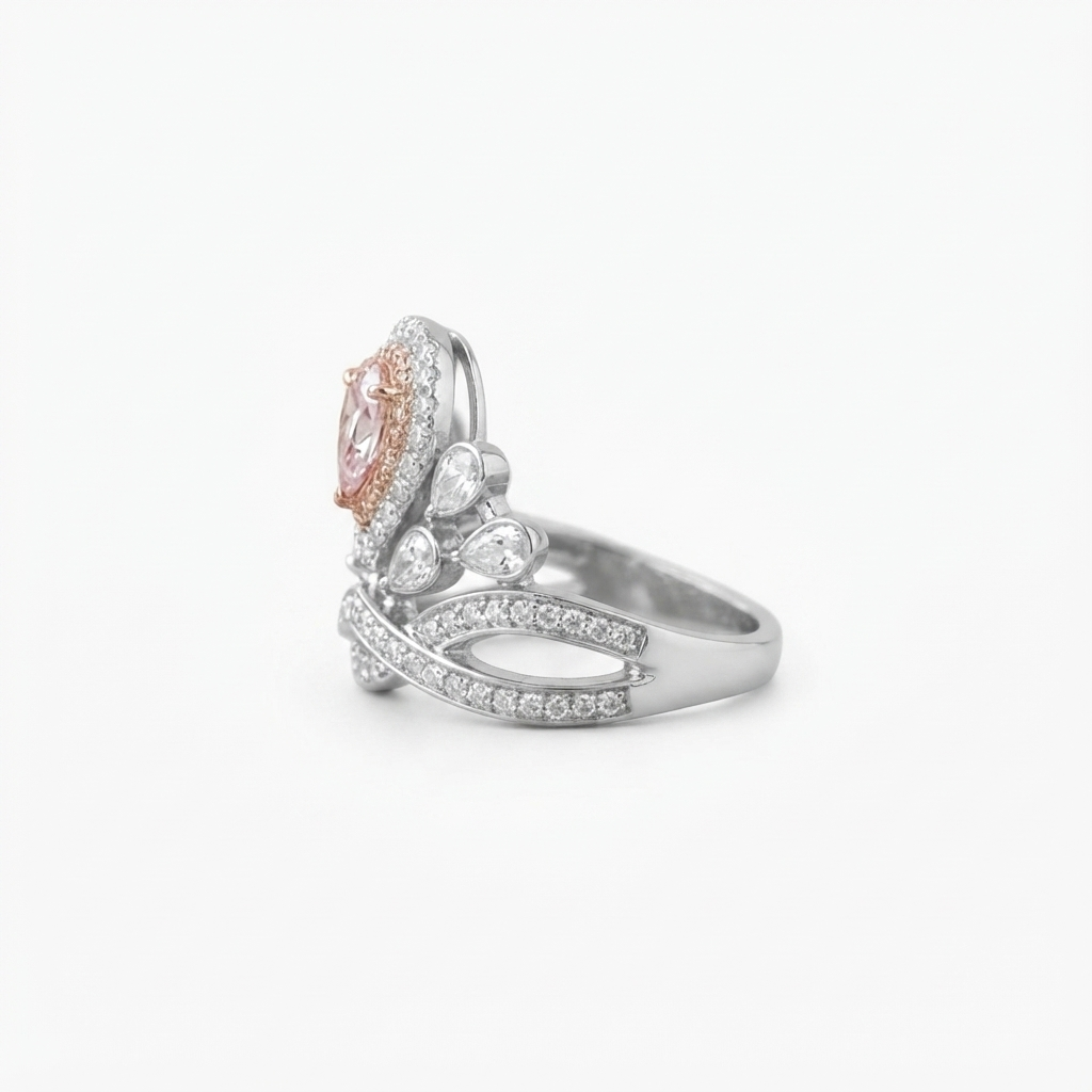 Right-side angle highlighting the sparkling band and halo settings of the pink pear cut lab grown diamond ring.