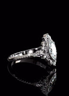 High-detail view of the vintage filigree scrollwork and faceted brilliance of a 3 carat marquise lab diamond.