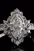 Close-up shot of a 3 CT marquise lab grown diamond center stone with delicate rope border and floral halo details.