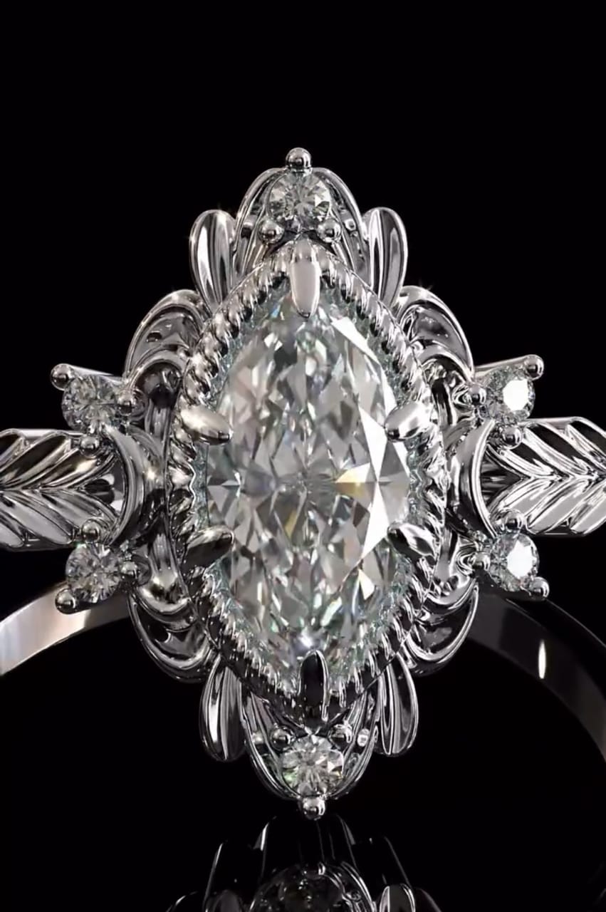 Close-up shot of a 3 CT marquise lab grown diamond center stone with delicate rope border and floral halo details.