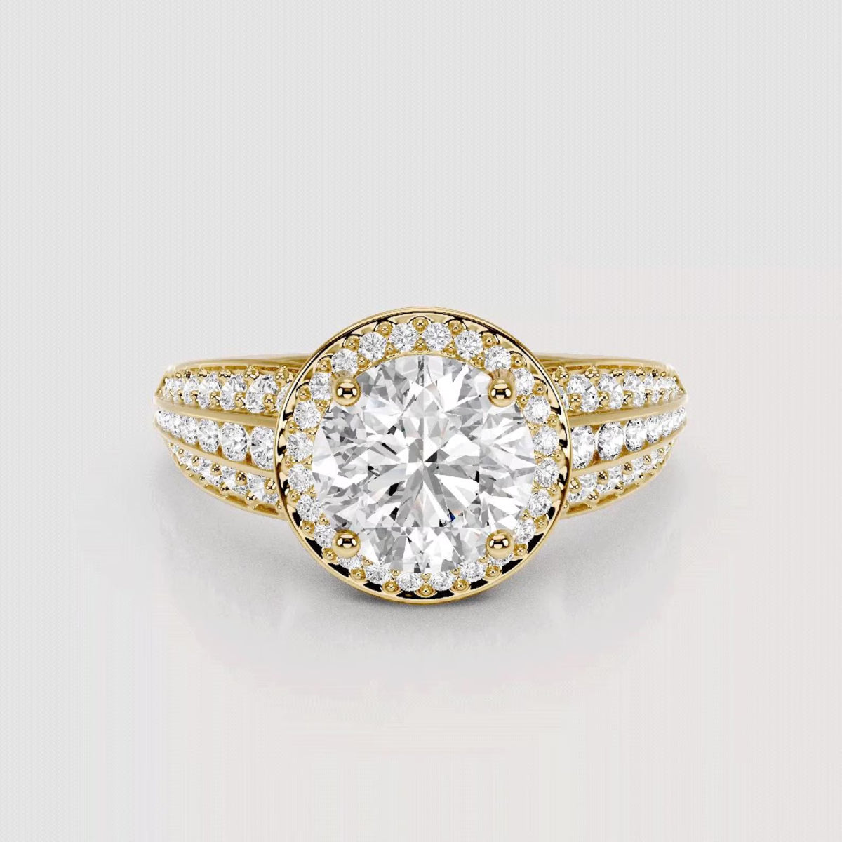 Top view of 3 CT round cut lab grown diamond triple band halo engagement ring in yellow gold.