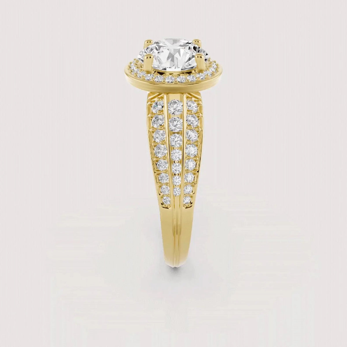 A yellow gold engagement ring featuring a large round-cut center stone and pavé-set diamond bands, shown on a light gray background.