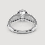 A polished silver-toned ring with a large clear gemstone in a prong setting, shown from a top-down view on a light gray background.