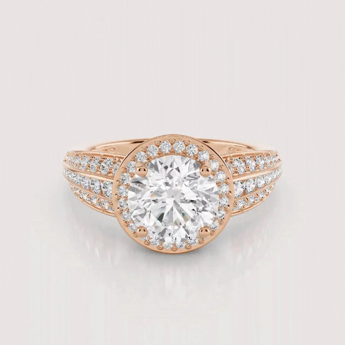 Direct top-down view emphasizing the sparkling center round diamond and multi-row pave halo structure in rose gold.