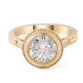 Direct top view of a 3 CT round lab grown diamond engagement ring with a double milgrain bezel setting in yellow gold.