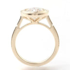 Side profile view of a 3 CT round lab grown diamond bezel ring showing cathedral shoulders in yellow gold.