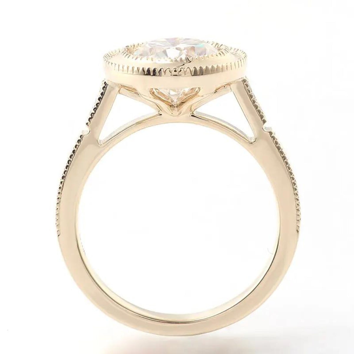 Side profile view of a 3 CT round lab grown diamond bezel ring showing cathedral shoulders in yellow gold.