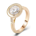Angled front perspective of a 3 CT round cut lab grown diamond ring with milgrain bezel rim in yellow gold.