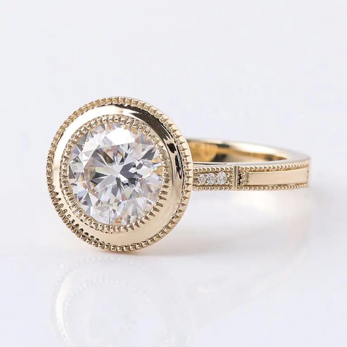 Perspective view highlighting the vintage milgrain band and side accents of a 3 CT round lab diamond ring in yellow gold.