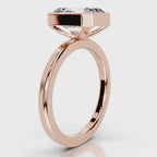 Side view of a 4 CT emerald cut lab diamond bezel ring set in rose gold.