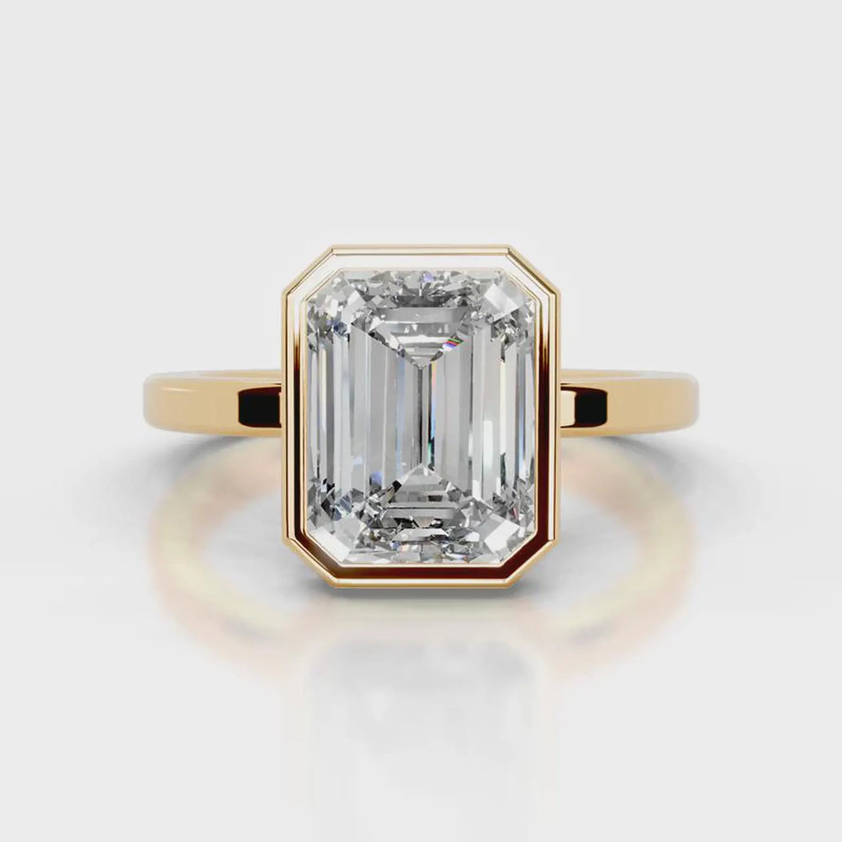Direct top-down view of a 4 CT emerald cut lab diamond in a full yellow gold bezel setting.