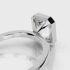 Under-gallery profile of a 4 CT emerald cut lab diamond solitaire ring with bezel frame in white gold.