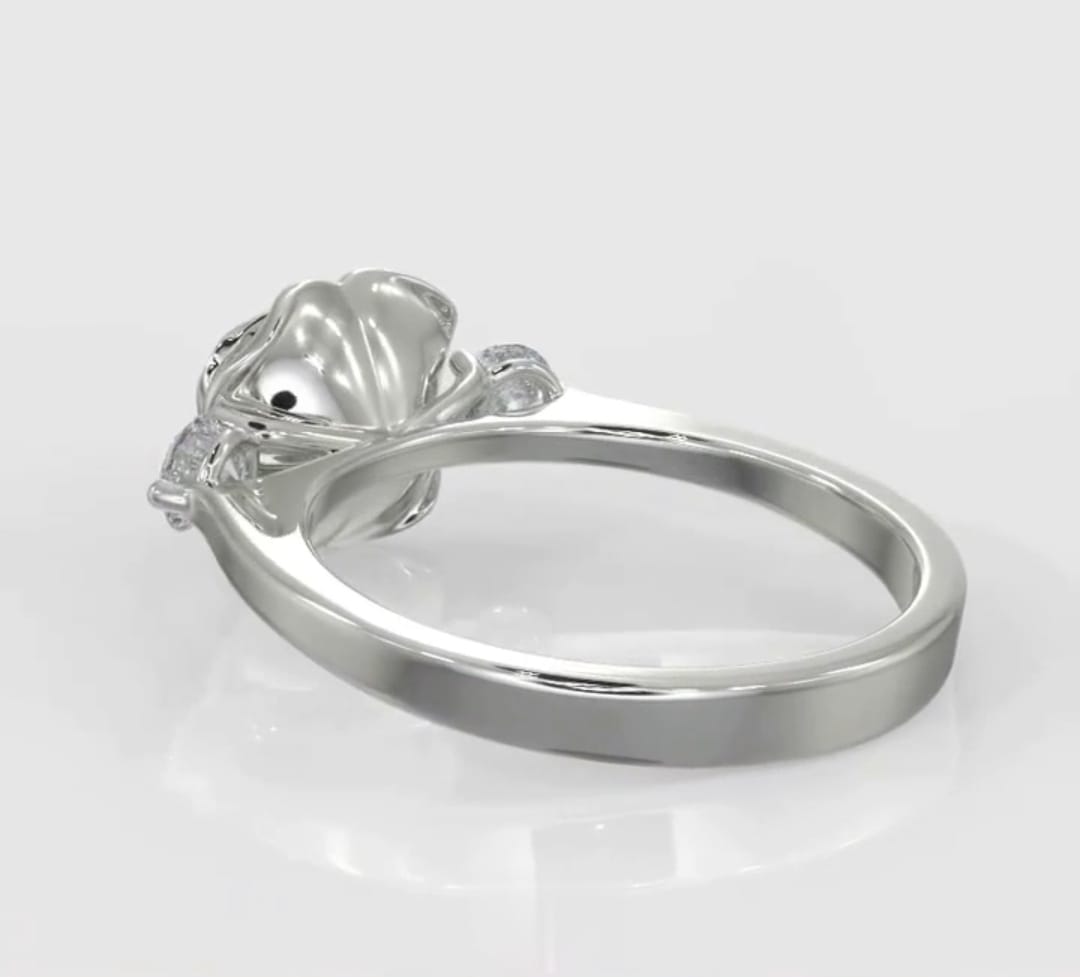 Underside side perspective view showing the smooth band and structural base of a sculpted rose lab diamond ring.