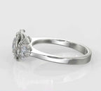 Side profile image of a round lab grown diamond set inside a sculpted metallic rose petal gallery with round side diamonds.