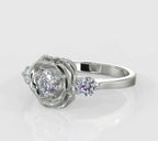 Angled top view showcasing a round brilliant lab diamond cradled in flower petals with two round side stones.