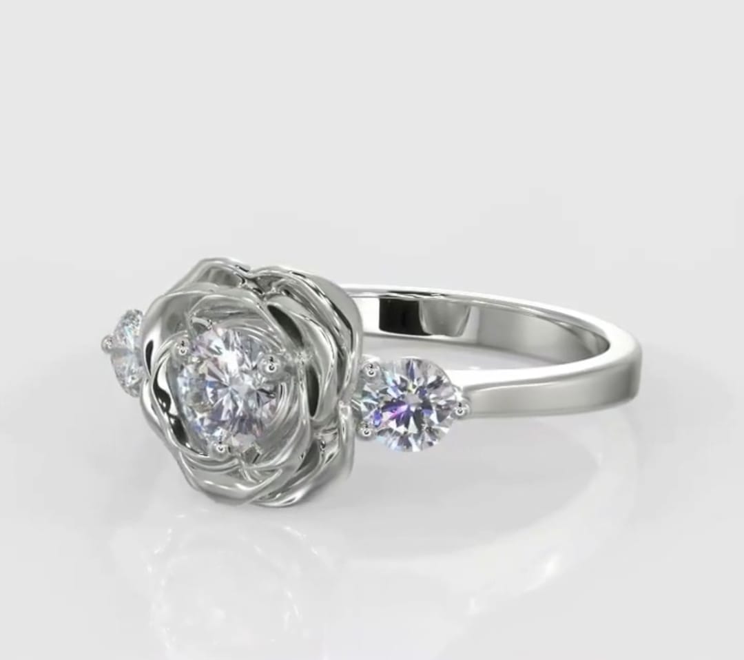 Angled top view showcasing a round brilliant lab diamond cradled in flower petals with two round side stones.
