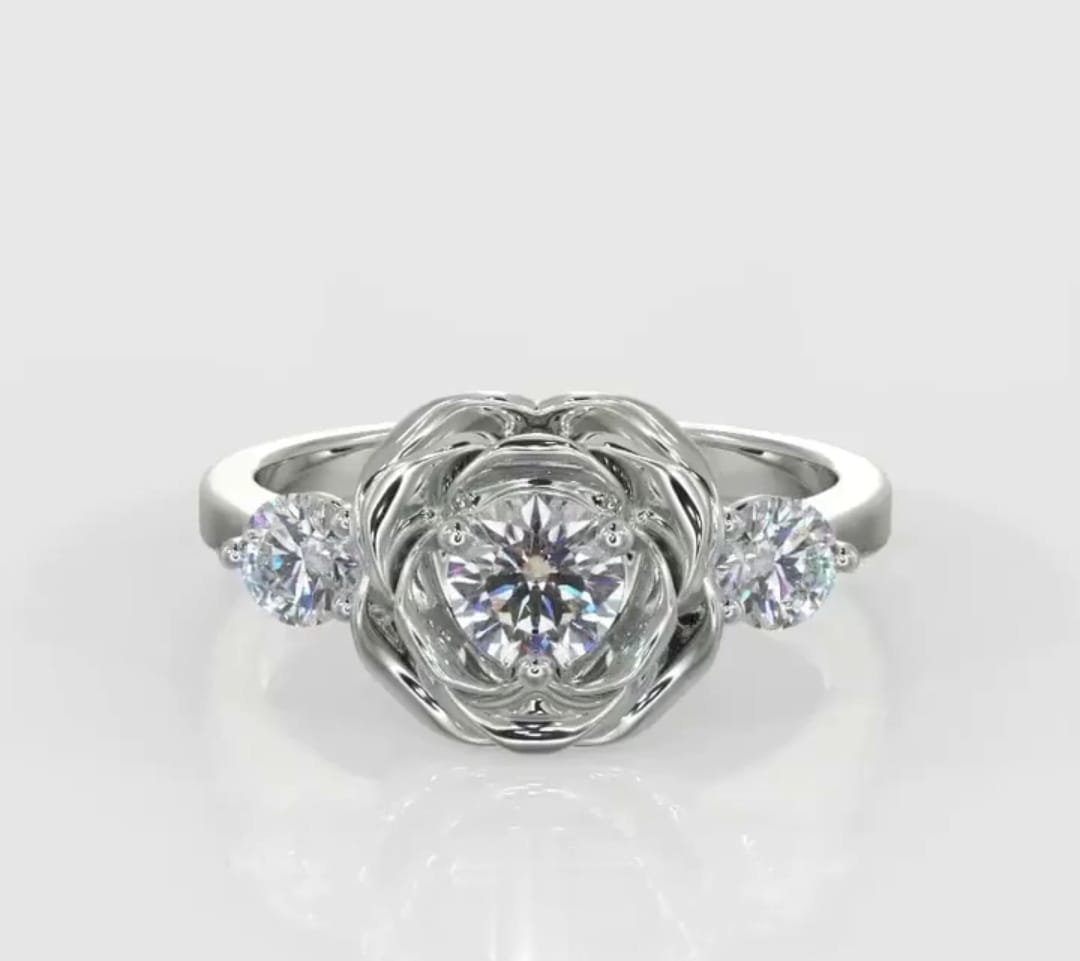 Direct top-down view of a round lab grown diamond rose engagement ring flanked by brilliant round side accents.