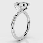 Side profile view of a 4 CT oval cut lab grown diamond bezel engagement ring in white gold.