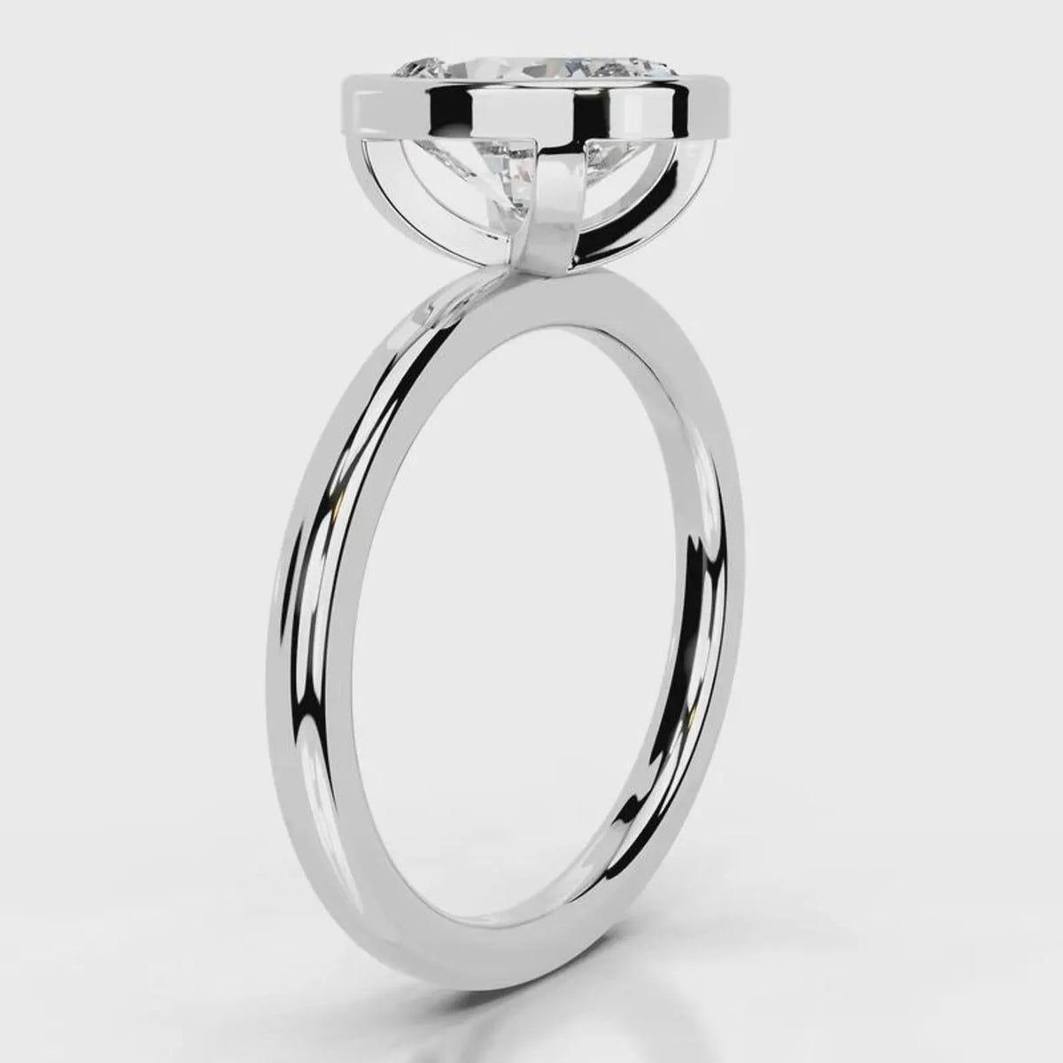 Side profile view of a 4 CT oval cut lab grown diamond bezel engagement ring in white gold.