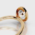 Detail of the open gallery setting under a 4 CT oval cut lab diamond ring in yellow gold.