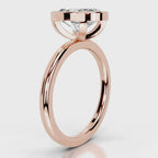 Side profile view of a 4 CT oval cut lab diamond bezel ring set in rose gold.