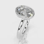 Angled top view of a 4 CT oval cut lab grown diamond bezel setting in white gold.